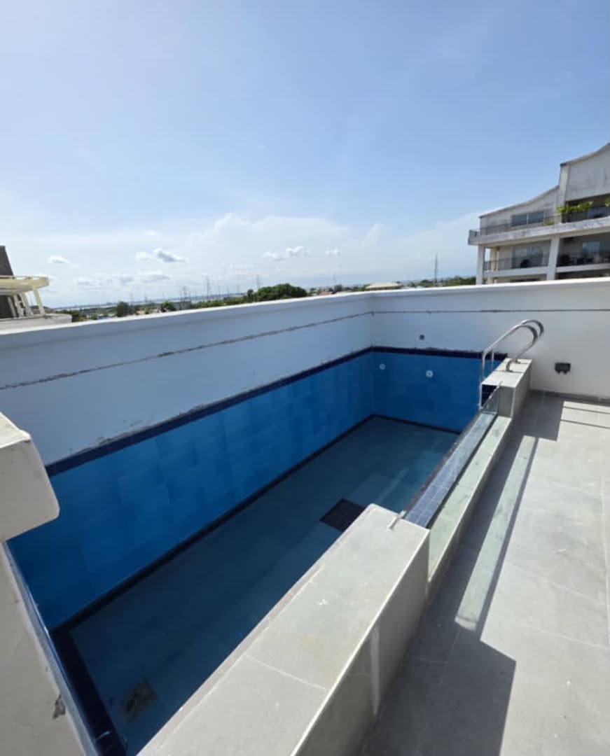Rooftop swimming pool at a managed residential facility, daytime